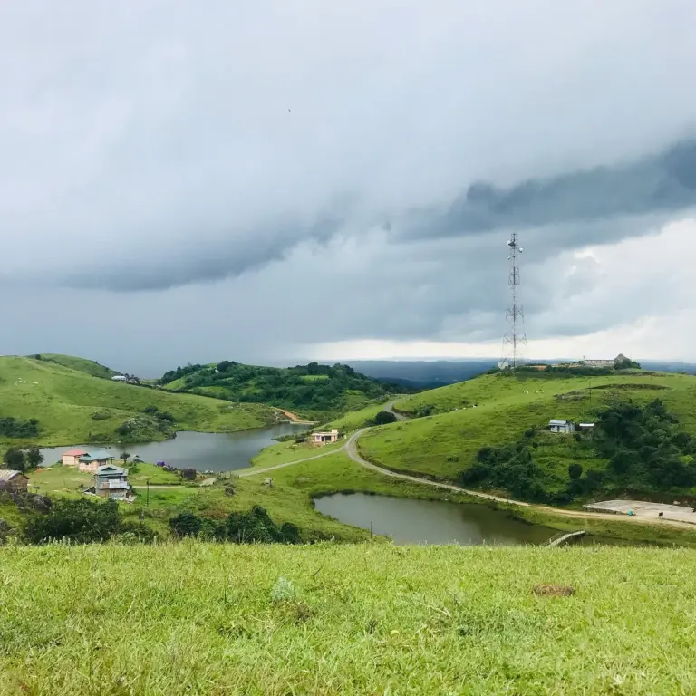 A cloudy day over the green hills, lakes, and cottages of Mawphanlur, Meghalaya