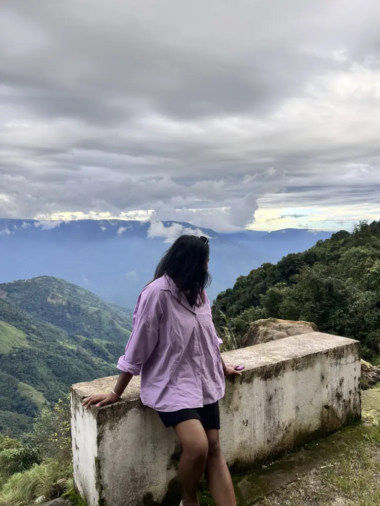A girl posing by a hill view at Mawlyngbna Meghalaya
