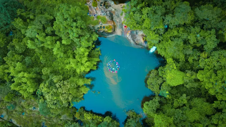 Aerial view of people in a circle formation during river canyoning at Mawlyngbna, Meghalaya
