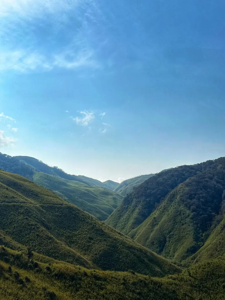 Bright blue sky over green hills in Dzukou Valley, Nagaland