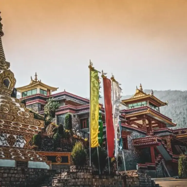 Colorful prayer flags and ornate structures at Dirang Monastery, Arunachal Pradesh