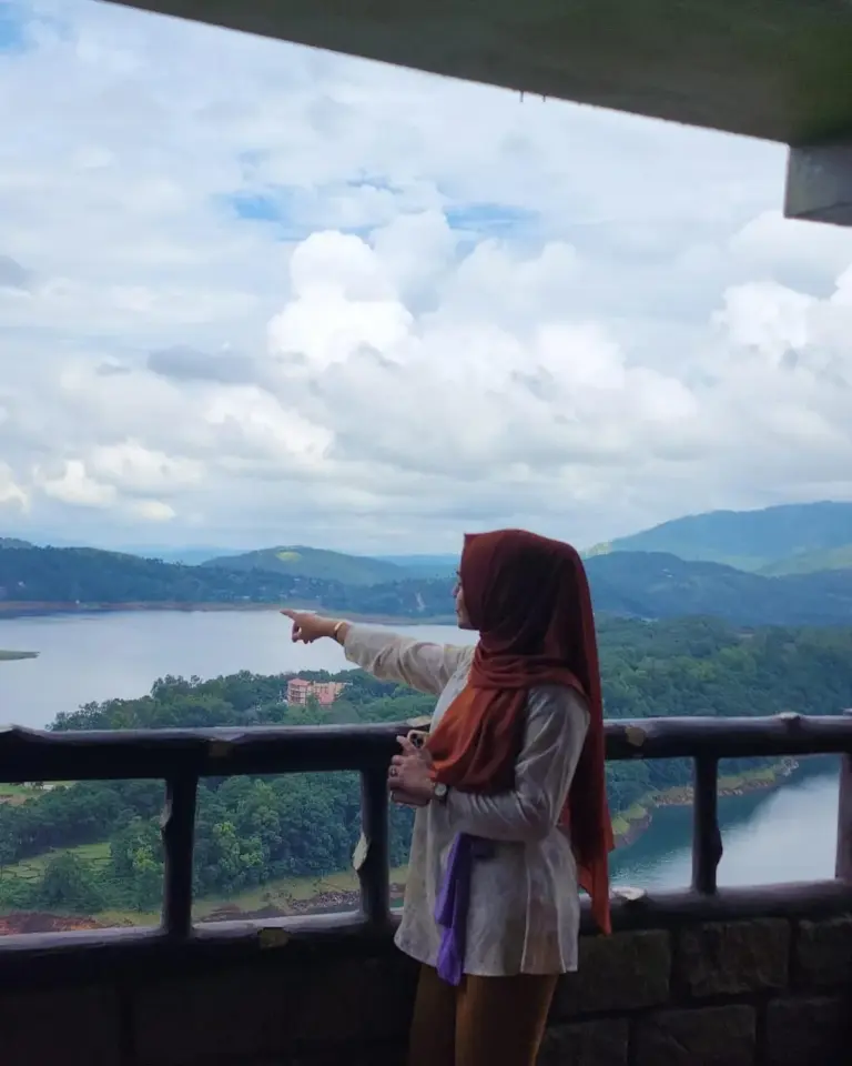 Girl enjoying the scenic view of Umiam Lake and surrounding hills in Meghalaya