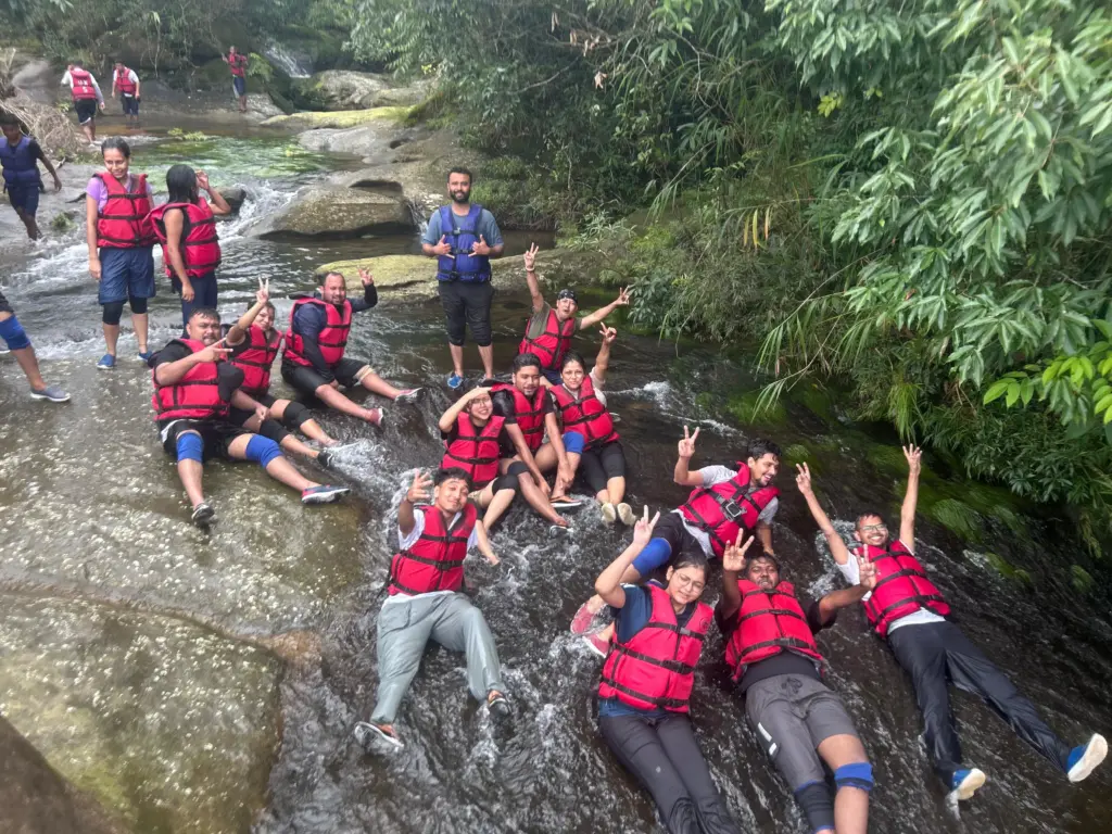 Group of people in life jackets enjoying a natural waterslide at Mawlyngbna Meghalaya