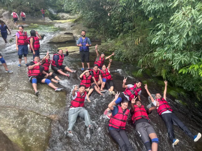 Group of people in life jackets enjoying a natural waterslide at Mawlyngbna Meghalaya
