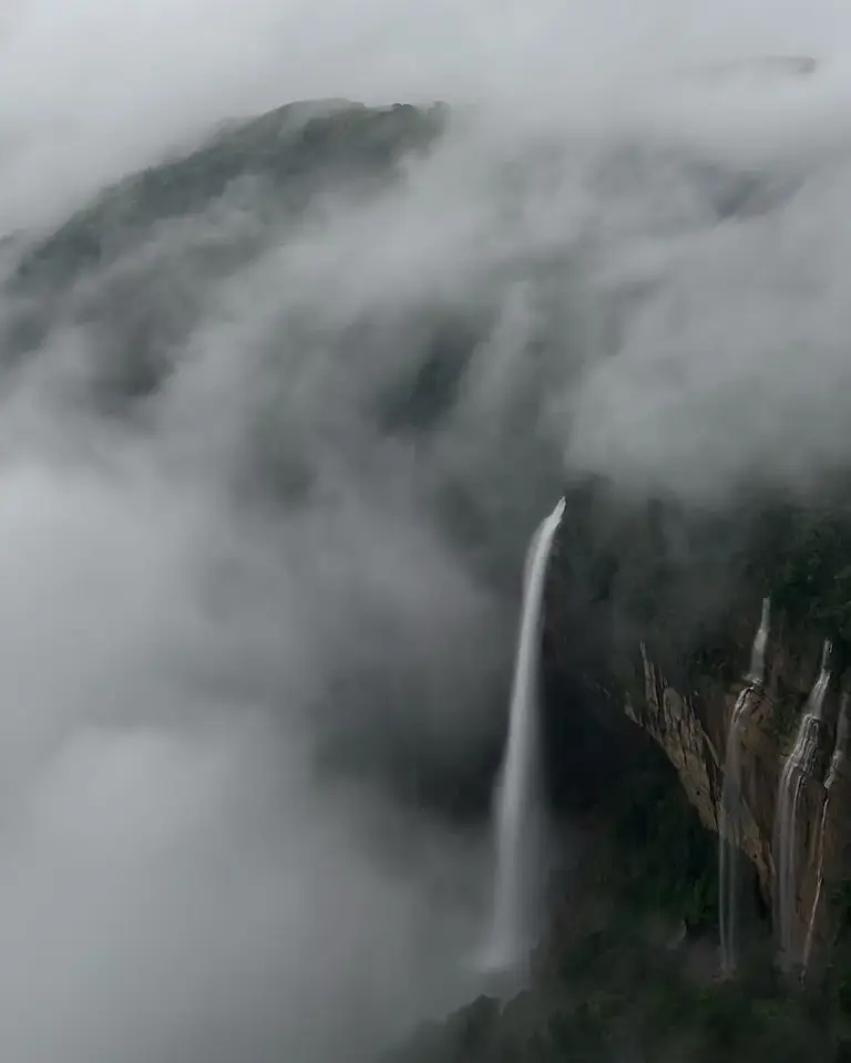 Misty view of Nohkalikai Falls cascading down a cliff in Meghalaya