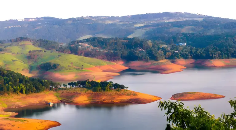 Panoramic view of Umiam Lake with lush green hills in Meghalaya