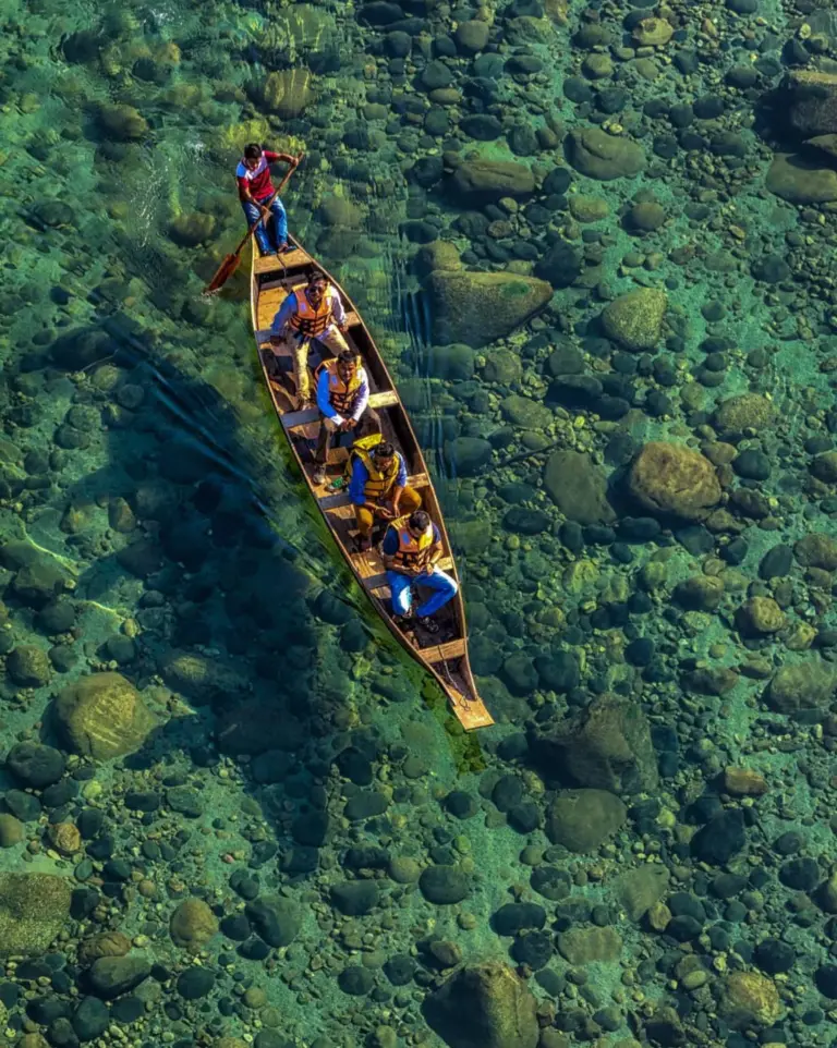 People boating on crystal-clear Umngot River, Dawki