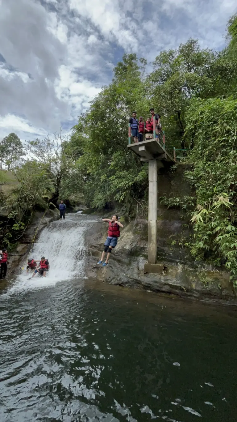 Person cliff jumping into water at Mawlyngbna Meghalaya