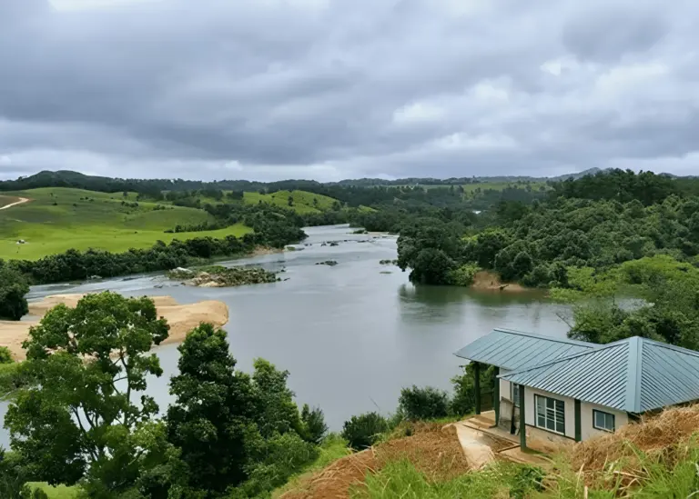 Riverside view with greenery and a small house on Nongkhnum Island, Meghalaya