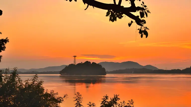 Scenic sunset view of Umananda Island and temple in the Brahmaputra River, Assam