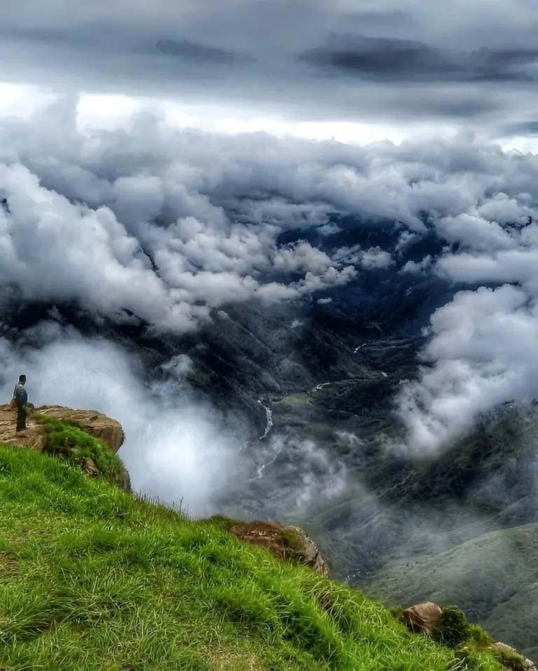 Scenic view from Laitlum in Meghalaya with clouds over green hills and deep valley