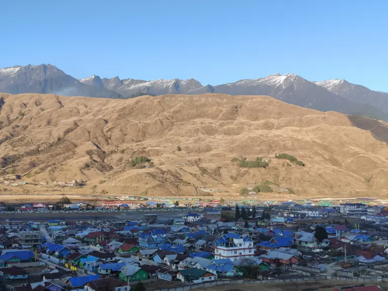 Scenic view of Mechuka town with colorful houses and surrounding mountains in Arunachal Pradesh