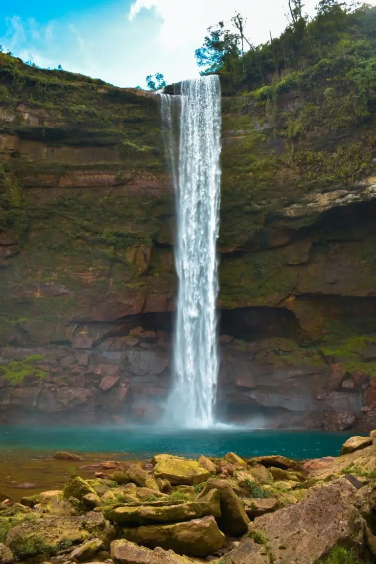 Scenic view of Phe Phe Falls cascading into a clear blue pool in Meghalaya