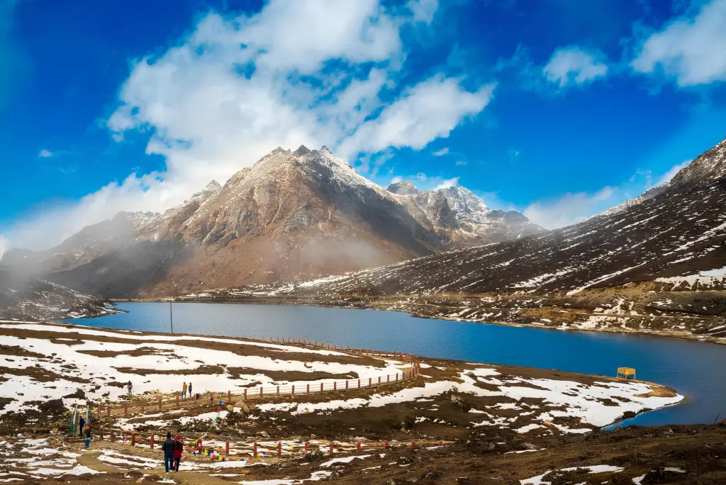 Sela Lake with snow-dusted mountains and a clear blue sky in Arunachal Pradesh
