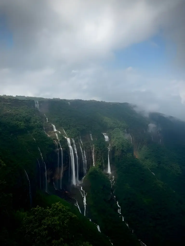 Seven Sisters Waterfalls cascading down lush green cliffs in Meghalaya