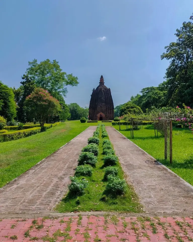 Shiva Doul temple in Assam surrounded by greenery and clear sky