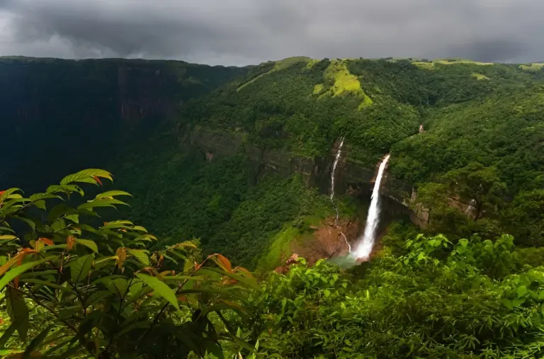 Tall waterfall cascading down lush green cliffs at Nohkalikai Falls Meghalaya 2