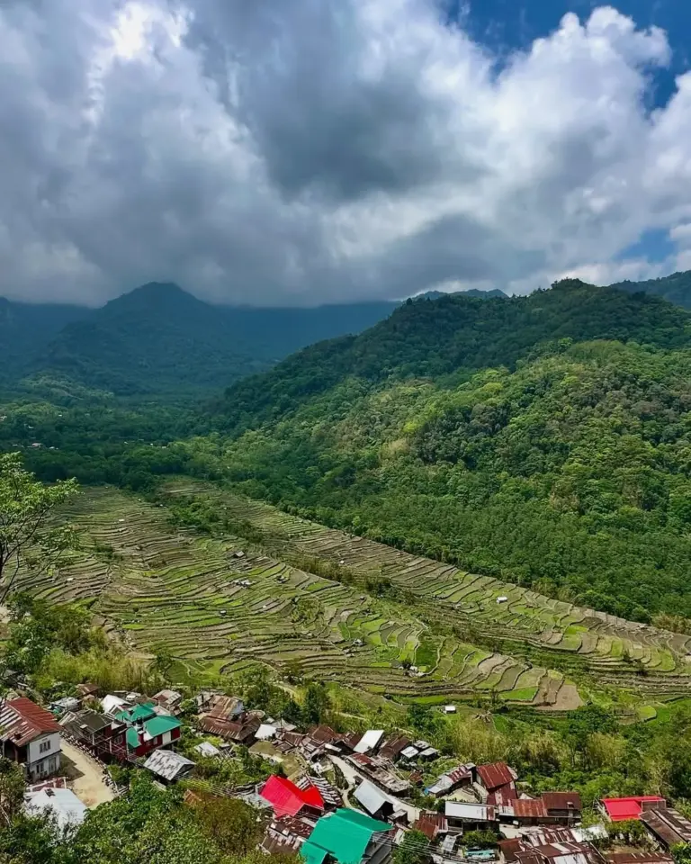 Terraced fields and colorful rooftops with lush green hills in Khonoma Village, Nagaland