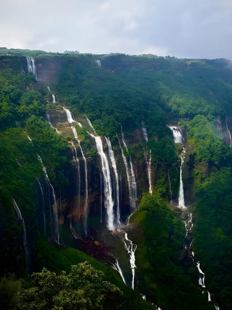 The Seven Sisters Waterfalls flowing down lush cliffs in Meghalaya