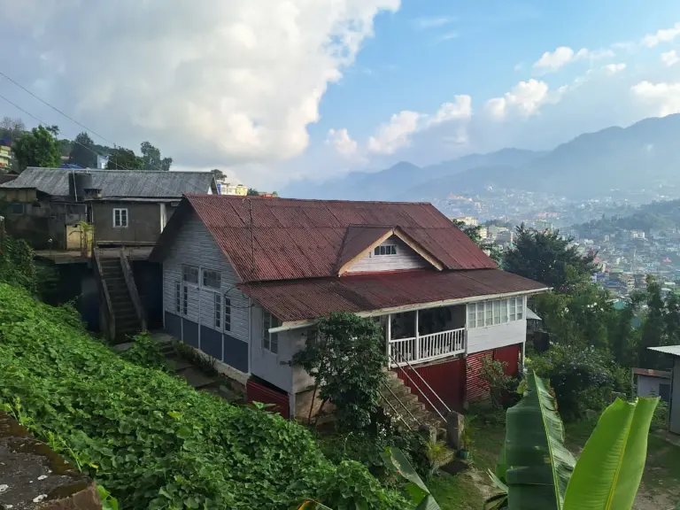 Traditional hillside house overlooking the city and mountains in Kohima