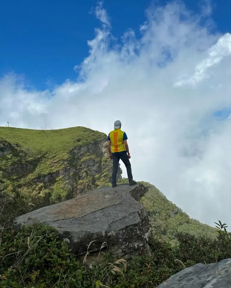 Trekker standing on a rock at Mount Japfu