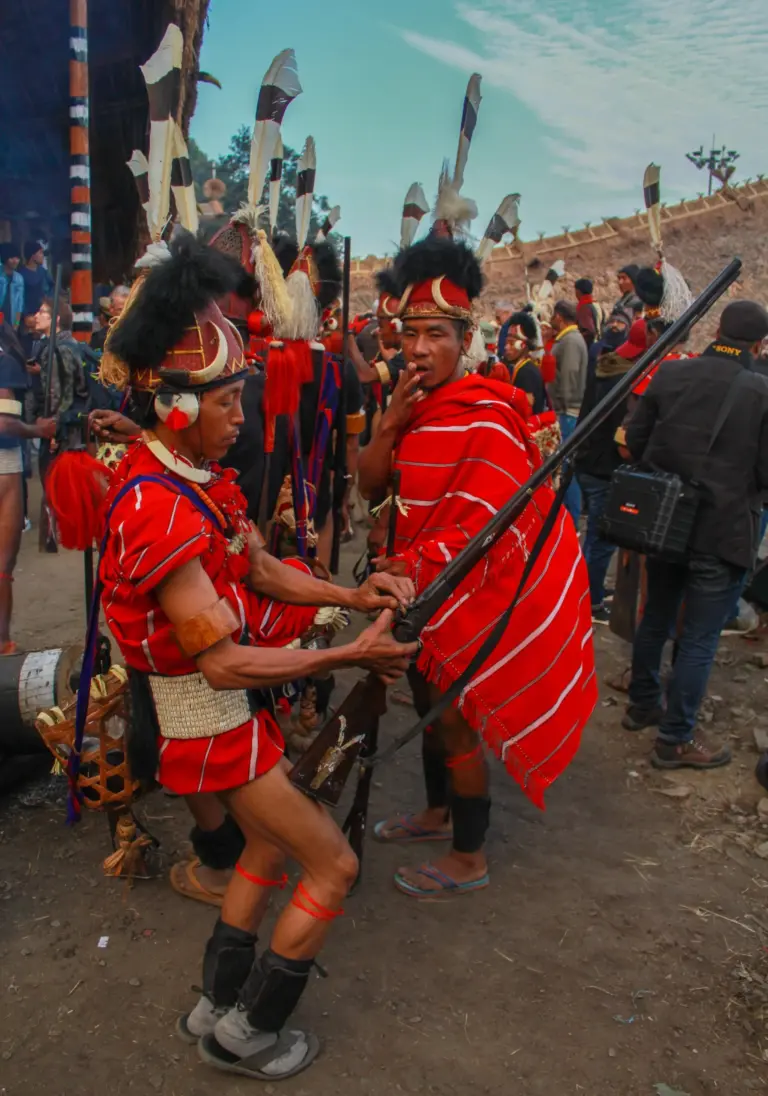 Tribesman in traditional red attire and feathered headgear at the Hornbill Festival