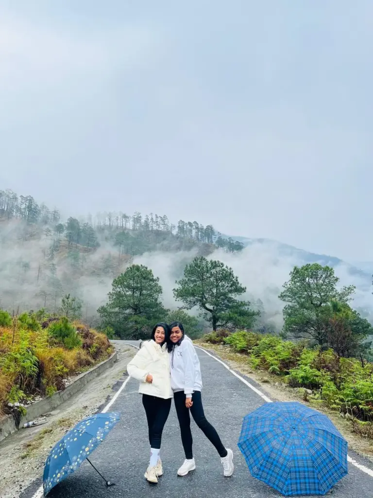 Two Girl posing on a misty road surrounded by greenery in Dong Valley