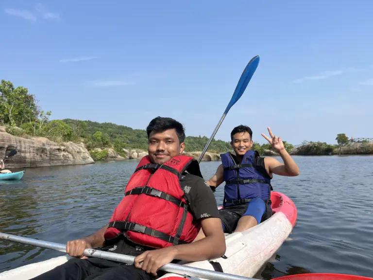 Two friends kayaking on a calm lake at Mawlyngbna, Meghalaya