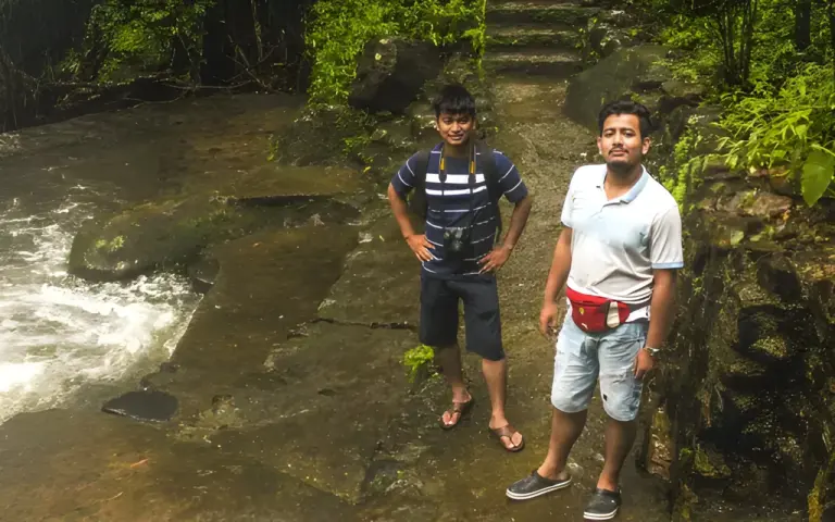 Two men standing near the Nongriat double decker living root bridge in Meghalaya