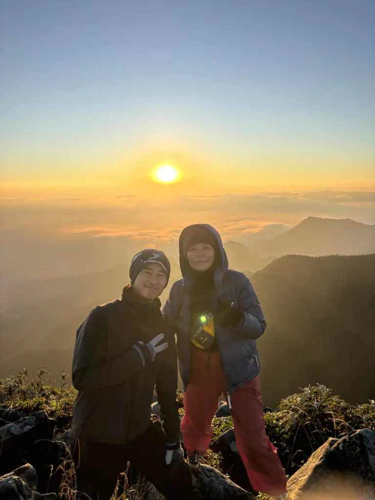 Two people at Japfu Peak during sunrise