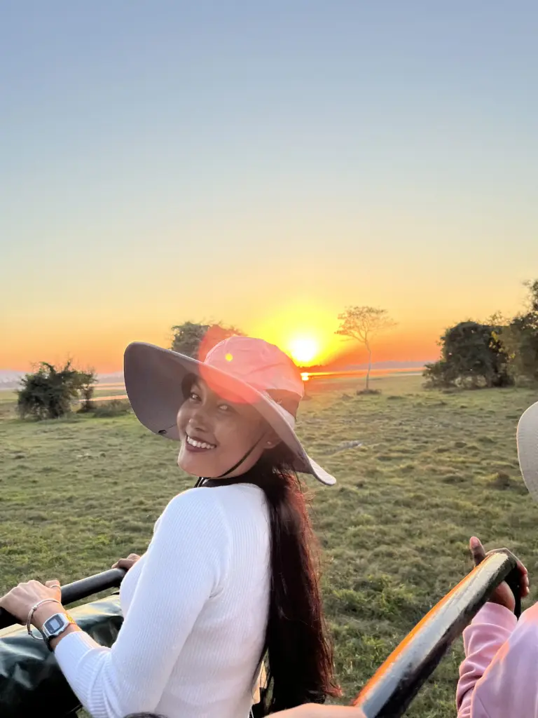 Visitor enjoying a sunset during a jeep safari in Kaziranga National Park Assam