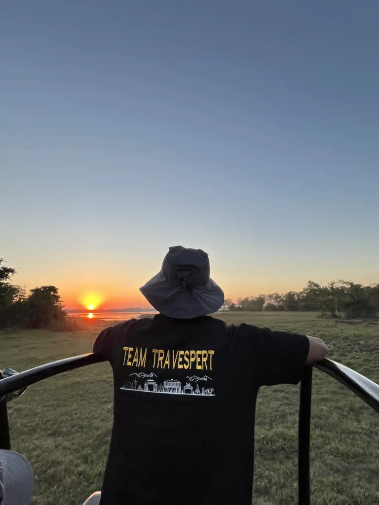 Visitor watching sunset during a jeep safari in Kaziranga National Park Assam
