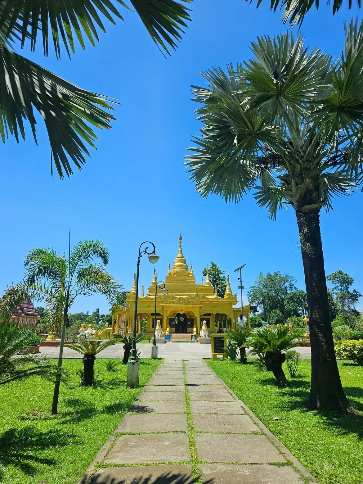 Golden Pagoda, Namsai, Arunachal Pradesh, surrounded by lush gardens and palm trees