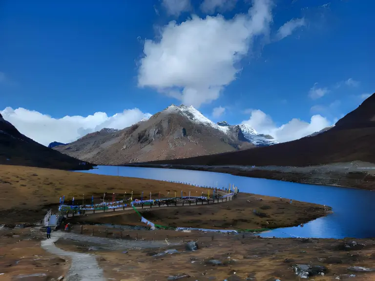 Sela Lake in Tawang beneath snow-capped mountains and a clear blue sky