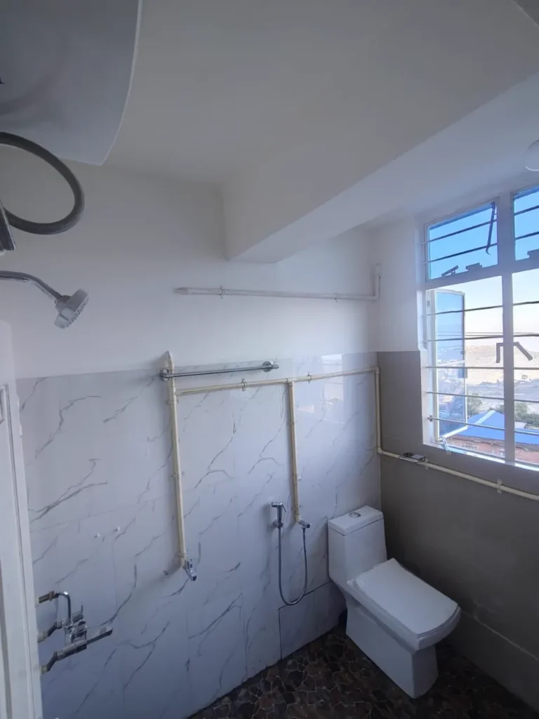 Attached bathroom with shower at Solace Homestay